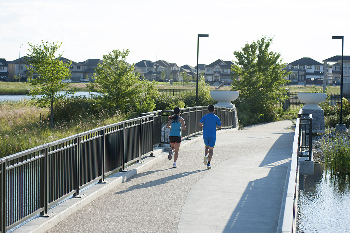 Couple jogging on Bridgwater bridge path